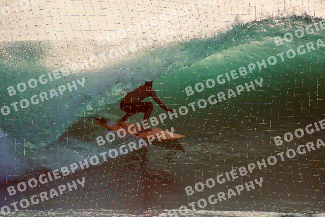 Surfer riding a green barrel at golden hour on an orange board, backlit spray blowing off the crest.